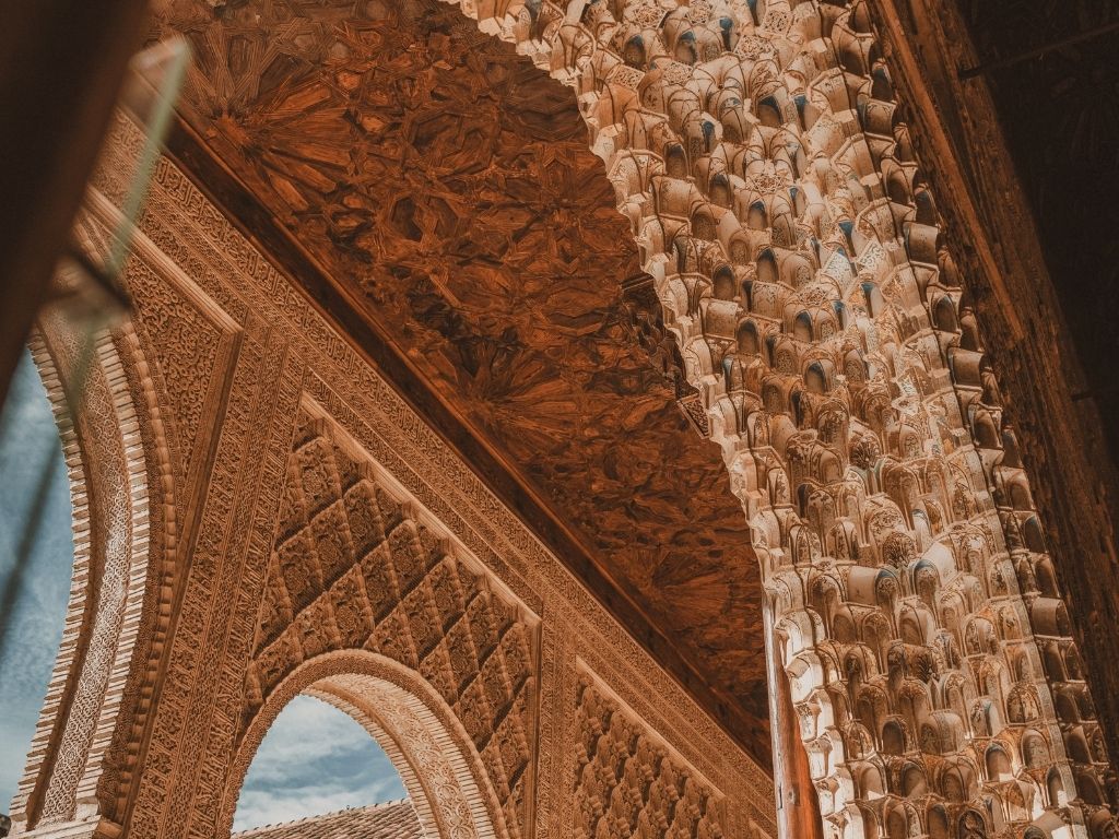 An ornate carved archway of dense lattice stonework