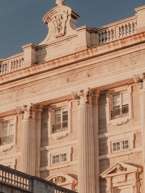 A neoclassical stone facade of heavy columns above a broad flight of steps