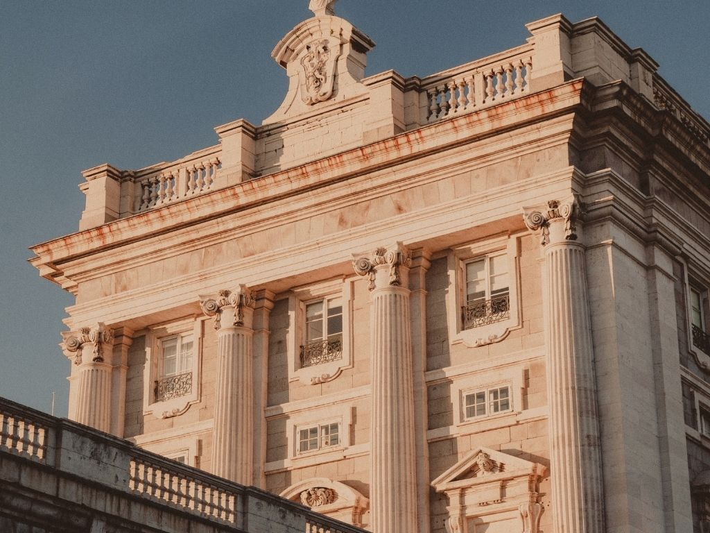 A neoclassical stone facade above a broad flight of steps, in full sun